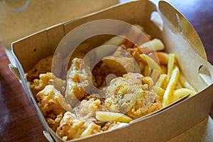 A delicious and crunchy Korean fried chicken served with fried rice cakes