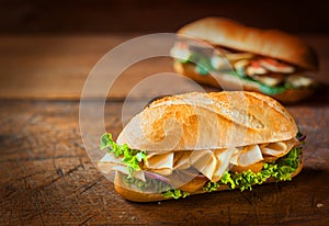 Delicious crusty ham roll on a rustic table