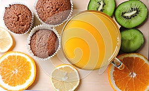 Delicious cupcakes with different cuts of juicy fruit