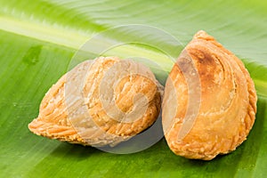 Delicious curry puffs on banana leaf