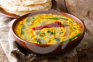 Delicious Dal Tadka recipe of yellow lentils with spices, herbs photo