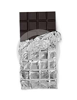 Delicious dark chocolate bar wrapped in foil isolated on white, top view