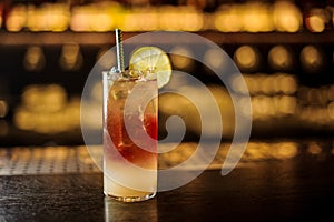 Delicious Dark Stormy cocktail decorated with lime slice on the bar counter