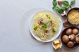 Delicious delicious pasta with mushrooms and Basil on a gray background. Italian food concept. Top view, copy space