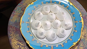 delicious dessert airy meringue cookies on a golden platter