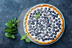 Delicious dessert blueberry tart with fresh berries and whipped cream, sweet tasty cheesecake, berry pie