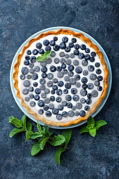 Delicious dessert blueberry tart with fresh berries and whipped cream, sweet tasty cheesecake, berry pie