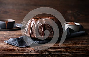 Delicious dessert, dark chocolate bundt cake topped with ganache glaze photo