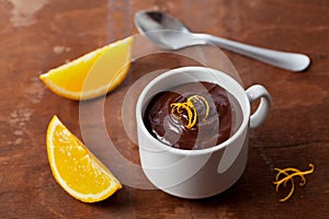 Delicious dessert from dark chocolate mousse with orange slice decorated citrus peel