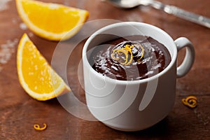 Delicious dessert from dark chocolate mousse with orange slice decorated citrus peel