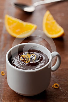 Delicious dessert from dark chocolate mousse with orange slice decorated citrus peel