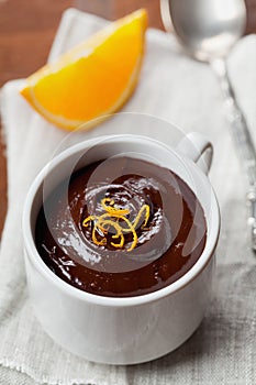 Delicious dessert from dark chocolate mousse with orange slice decorated citrus peel