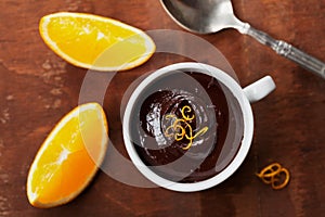 Delicious dessert from dark chocolate mousse with orange slice decorated citrus peel