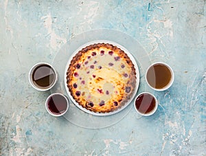 Delicious dessert on a plate with four kinds of tea. Sweet tasty cheesecake with fresh berries. Top view