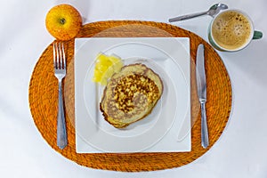Delicious dietary breakfast of a pancake with pineapple, an apple, coffee, served