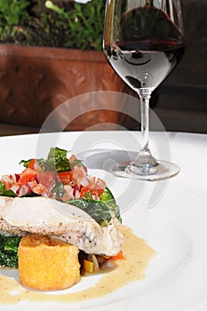 Delicious dinner with Fish and red wine photo