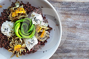Delicious dish with Avocado, cheese, corn and sprouted wheat grains.