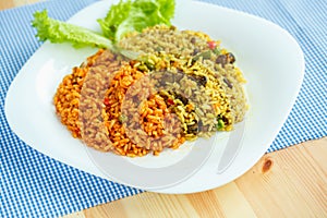 Delicious dish made of two kinds of rice on a white plate