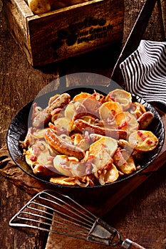 Delicious dish of potatoes, Nuremberger bratwurst and bacon