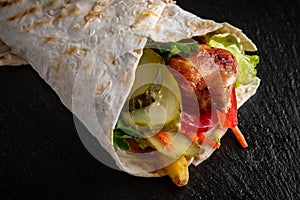 A delicious doner donair kebab wrap with meat, lettuce, tomato, red onion photo