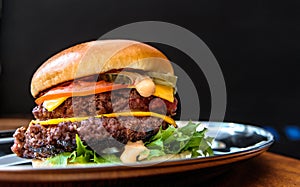 Delicious Double Cheeseburger on a metal plate