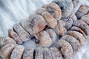Delicious dried figs strung on a rope. Organic snack. Vegetarian, healthy food. Closeup