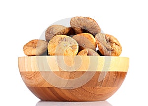 Delicious dried figs in wooden bowl