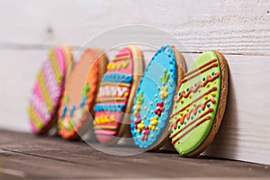 Delicious Easter cookies background. Colorful Easter cookies all over white wooden background. Eggs with different