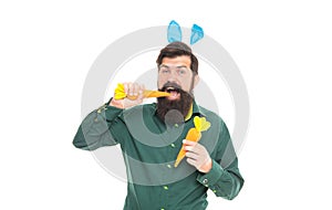 Delicious Easter treats. eastertide. happy bearded man wear bunny ears. happy easter carrot.