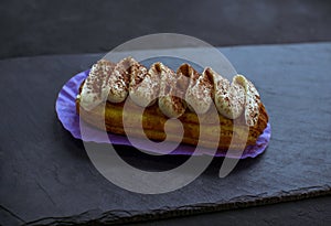 Delicious eclair cake - tiramisu flavoured covered with cream