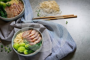 Delicious egg noodle with red pork and vegetable in bowl