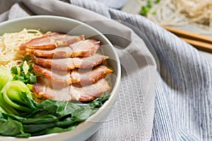 delicious egg noodle with red pork and vegetable in bowl decoration