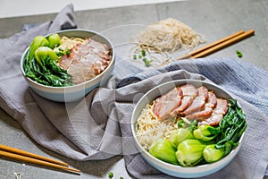 delicious egg noodle with red pork and vegetable in bowl decoration