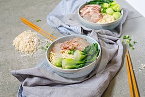 delicious egg noodle with red pork and vegetable in bowl decoration.