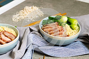 delicious egg noodle with red pork and vegetable in bowl decoration