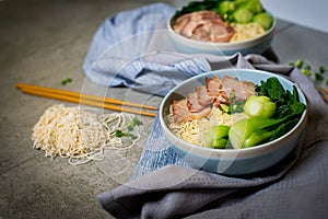 Delicious egg noodle with red pork and vegetable in bowl