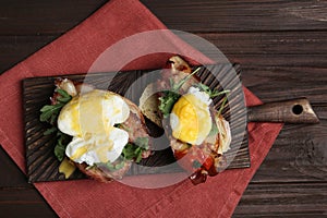 Delicious eggs Benedict served on table, flat lay