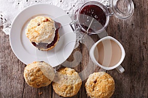 Delicious English scones with jam and tea close-up. Horizontal t