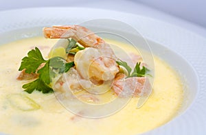 Delicious exotic shrimp cream soup with parsley and lemon cooked for gourmets photo