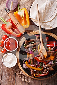 Delicious fajitas on a table in a rustic style. vertical top vie