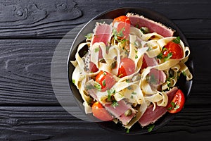 Delicious fettuccine pasta with tuna steak, tomatoes and capers