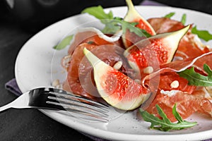 Delicious figs and proscuitto on plate, closeup