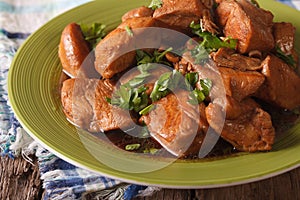 Delicious Filipino Food: Adobo chicken with herbs close-up. horizontal