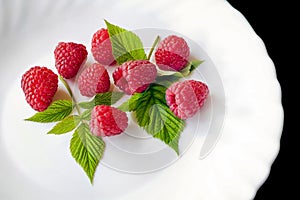 Delicious first class fresh raspberries in plate