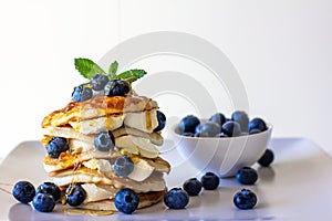 Delicious Flapjack breakfast with cream cheese, fresh blueberries and drizzled with honey