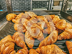 Delicious and fluffy ready-to-eat croissants. It is a bun of Austrian origin made with puff pastry, yeast and butter photo