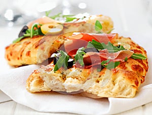 Delicious focaccia bread with ham and rocket