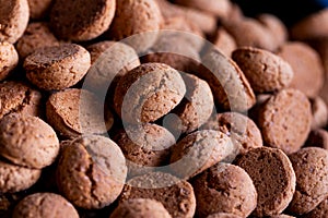 A delicious food portrait of a pile of tasty traditional dutch snacks called pepernoten or pepernuts. The gingerbread treat is a