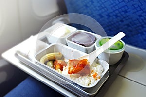 Delicious food served on board of economy class airplane on the table