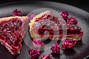 Delicious fragrant sweet pie with cherry berries on a ceramic plate